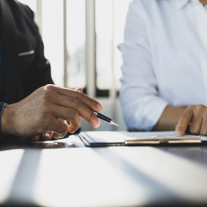 Businessman showing an insurance policy to sign. Insurance agent consulting insurance to customer.