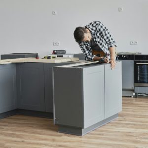 Carpenter mounting kitchen furniture